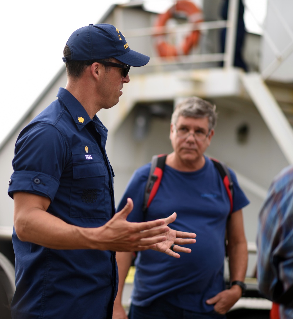 Coast Guard Cutter Fir's commanding officer speaks with crewmembers of the Panama Port Authority before demonstration