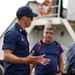 Coast Guard Cutter Fir's commanding officer speaks with crewmembers of the Panama Port Authority before demonstration