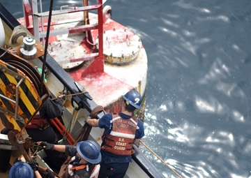 Coast Guard Cutter Fir crewmembers rig a Panamanian whistle buoy before lifting it out of the ocean