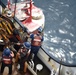 Coast Guard Cutter Fir crewmembers rig a Panamanian whistle buoy before lifting it out of the ocean