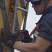 A Coast Guard Cutter Fir guardsman prepares to lift a whistle buoy out of the Port of Panama