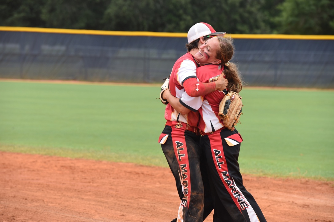 PENSACOLA, Fla. – Marine Sgt. Katie Dunkelberger celebrates with her teammate, Sgt. Michele Cox, during the third round of the 2018 Armed Forces Women's Softball Championship, Aug. 17. Teams from the Navy, Army, Air Force and Marine Corps competed to determine a military women's softball champion. (U.S. Navy photo by Mass Communication Specialist 1st Class Christopher Hurd/Released)