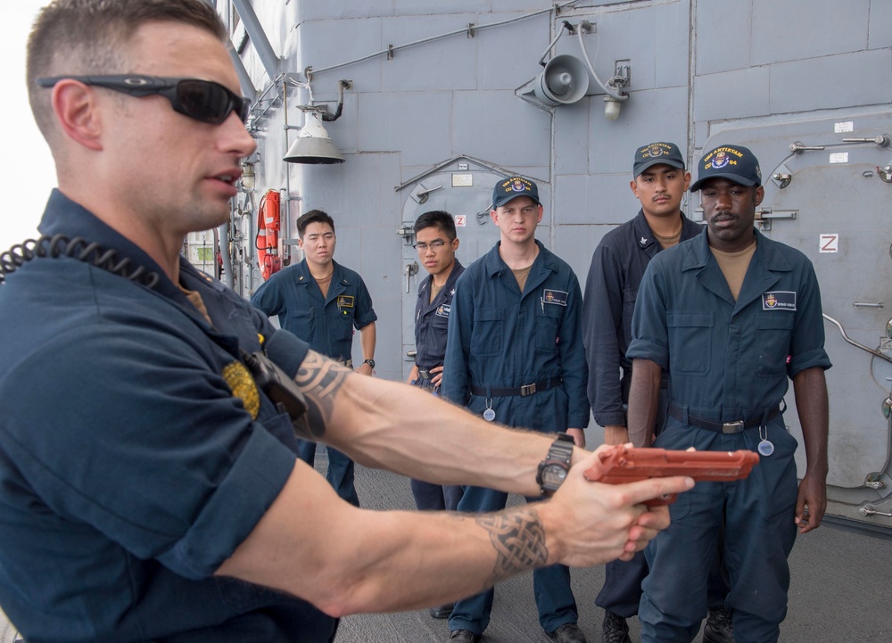 Sailors assigned to the Ticonderoga-class guided-missile cruiser USS Antietam (CG 54) observe a demonstration during a shipâ€™s reaction force security training exercise