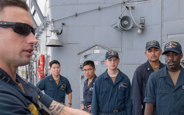 Sailors assigned to the Ticonderoga-class guided-missile cruiser USS Antietam (CG 54) observe a demonstration during a shipâ€™s reaction force security training exercise