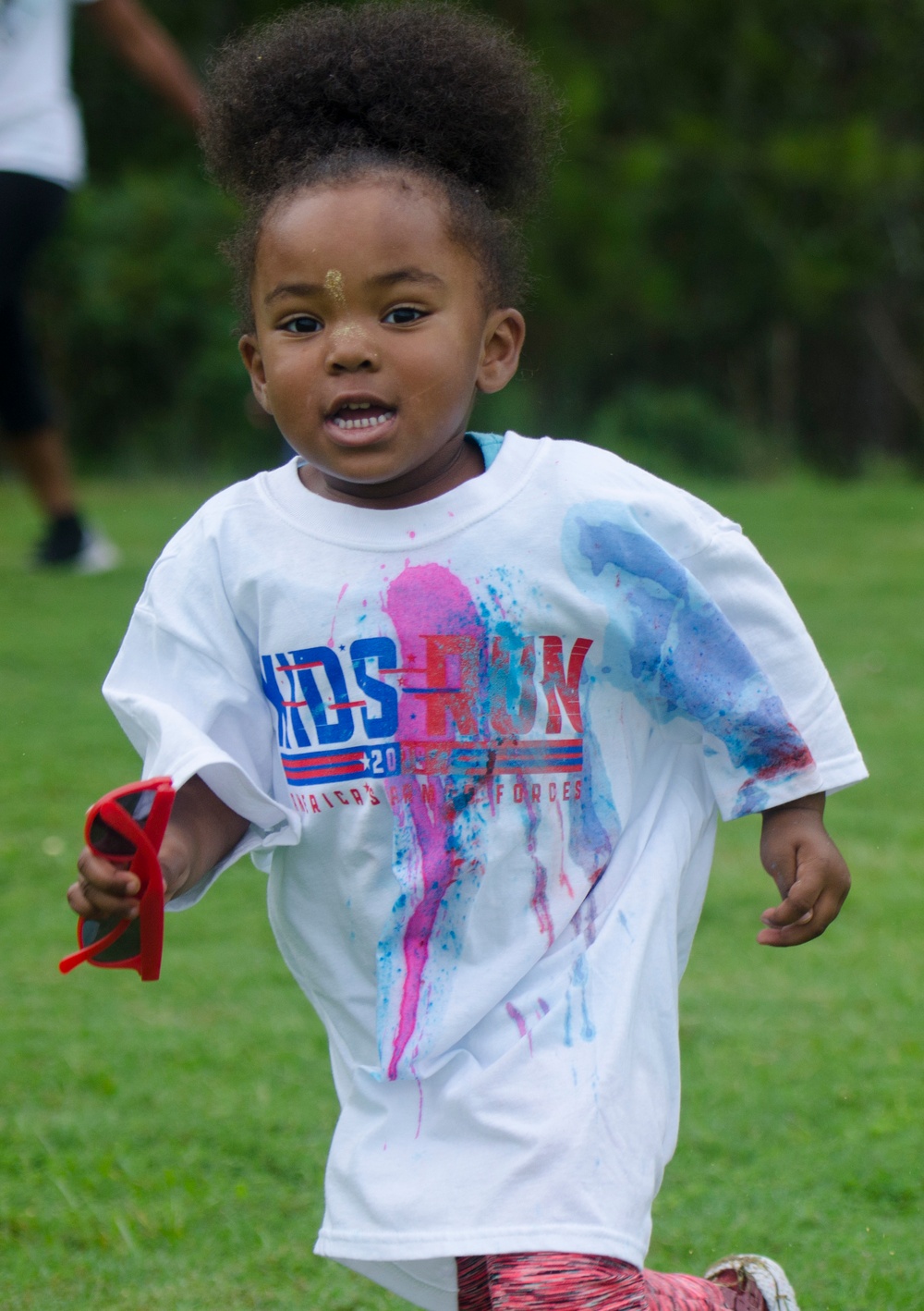 A young runner sprints past as the volunteers from the Basic Officer Leader Course 007 splash them with color during the 4th Annual Back-to-School Color Run and Field Day held on Fort Jackson, Aug 18. &quot;We do this just to get the kids fired up for school