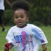 A young runner sprints past as the volunteers from the Basic Officer Leader Course 007 splash them with color during the 4th Annual Back-to-School Color Run and Field Day held on Fort Jackson, Aug 18. &quot;We do this just to get the kids fired up for school
