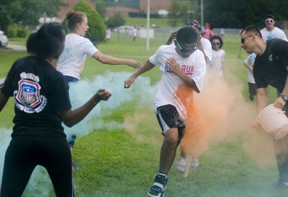Volunteers from the Basic Officer Leader Course 007 splash the participants with color as they run by during the 4th Annual Back-to-School Color Run and Field Day held on Fort Jackson, Aug 18. &quot;We do this just to get the kids fired up for school and bri