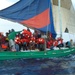 A Sail freighter with 105 Haitian migrants aboard makes way to Haiti while the Coast Guard Cutter Northland escorts them back to safety