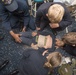 Hospital Corpsman 2nd Class Devina Gutual, from Salinas, CA, receives medical attention as a simulated casualty during a general quarters training exercise on the Ticonderoga-class guided-missile cruiser USS Antietam (CG 54).