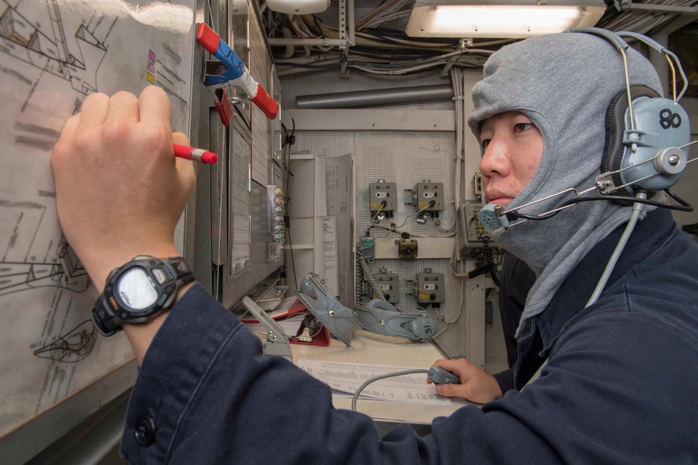 Ensign Francis Lee, from Garden Grove, CA, engages in a general quarters training exercise on the Ticonderoga-class guided-missile cruiser USS Antietam (CG 54)