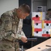 Coalition members with Task Force Battle compete in the Combined Joint Task Force-Operation Inherent Resolve Monthly/Quarterly Joint Service Board, which consists of a physical fitness test, hands-on weapons test, written test, and face to face board.