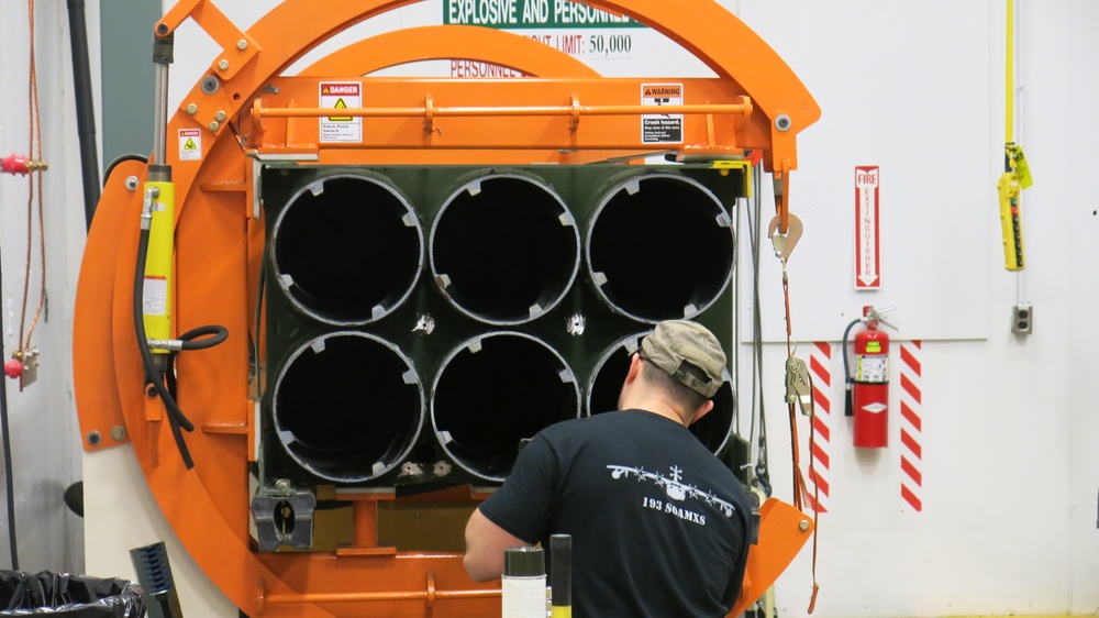 A Letterkenny Munitions Center employee modifies a Multiple Launch Rocket System pod for reuse in Low Cost Reduced Range Practice Rocket production at Letterkenny Munitions Center.