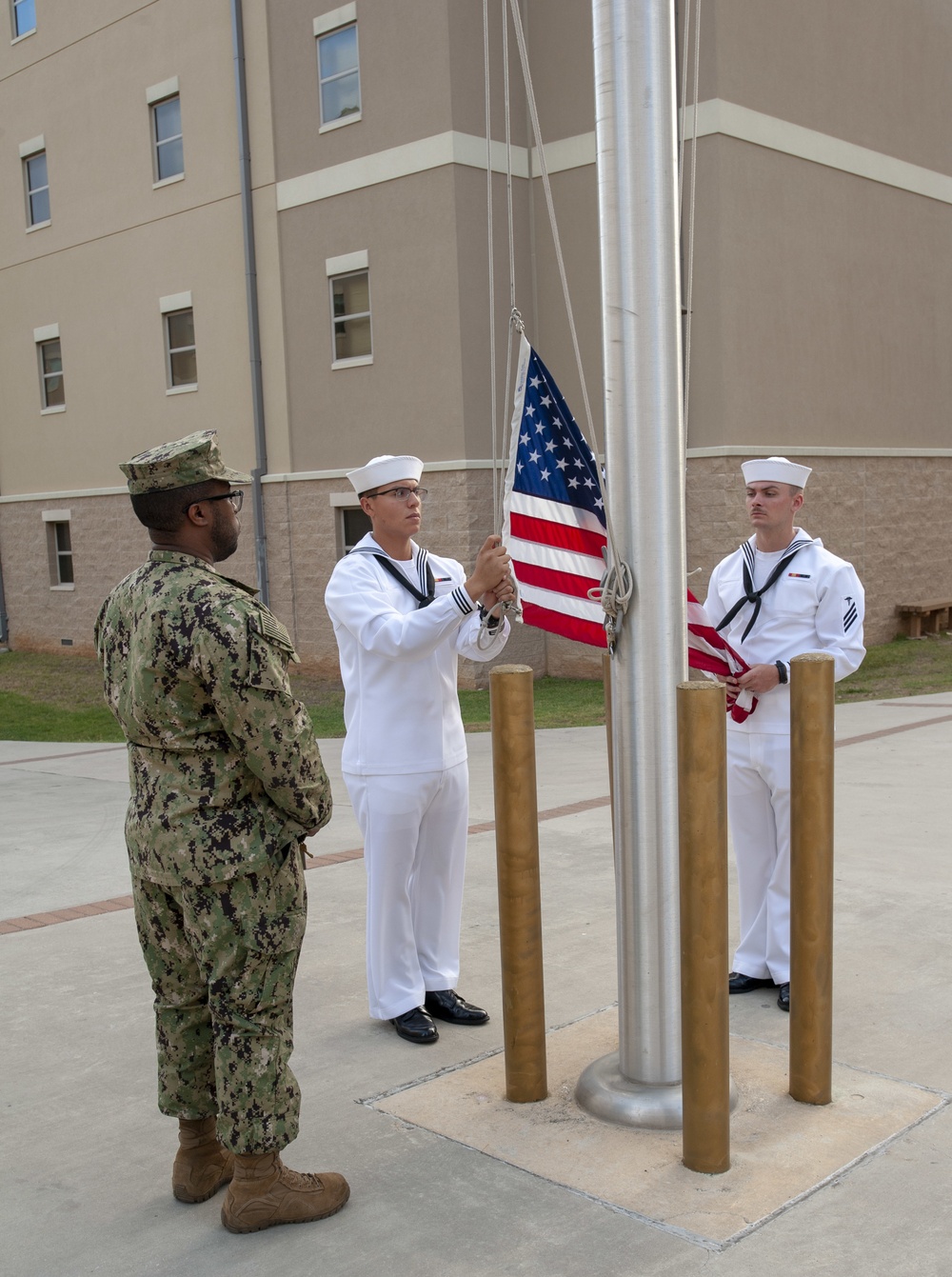 NMTSC Sailors Hoist Flag to Half-Staff