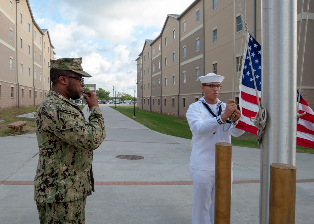 NMTSC Sailors Hoist Flag to Half-Staff