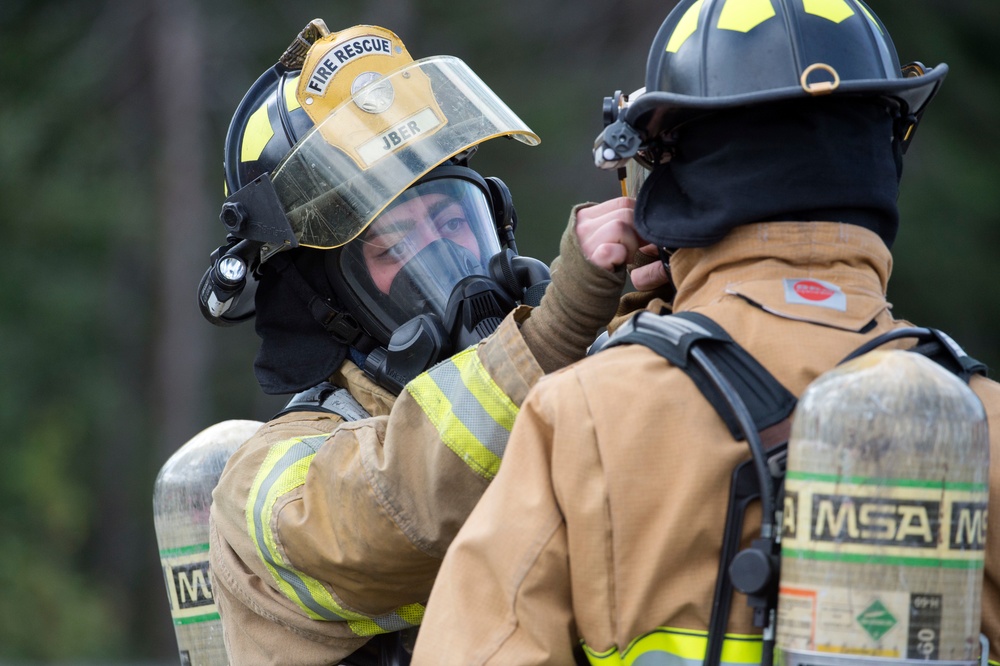 Air Force firefighters conduct wartime-firefighting readiness training at JBER Air Force firefighters conduct wartime-firefighting readiness training at JBER