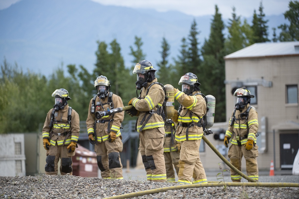 Air Force firefighters conduct wartime-firefighting readiness training at JBER Air Force firefighters conduct wartime-firefighting readiness training at JBER