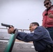 Sailors shoot guns for pistol qualification on USS Jason Dunham