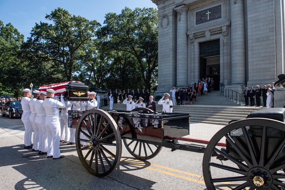 Navy Body Bearers place the casket of the late Sen. John McCain onto a horse-drawn caisson
