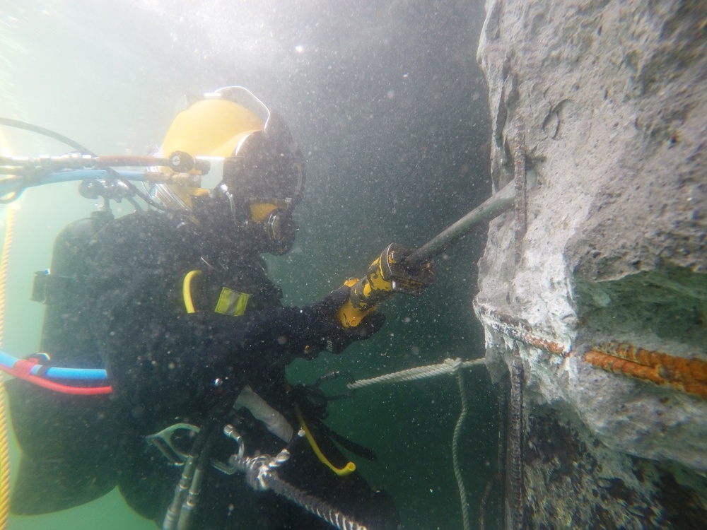 UCT 2 CDD/C removes deteriorated concrete as part of repairs to the Harbor Master Pier in Yokosuka, Japan.