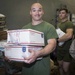 Marines and Sailors receive food supplies and mail during a replenishment-at-sea