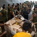 Marines and Sailors receive food supplies and mail during a replenishment-at-sea