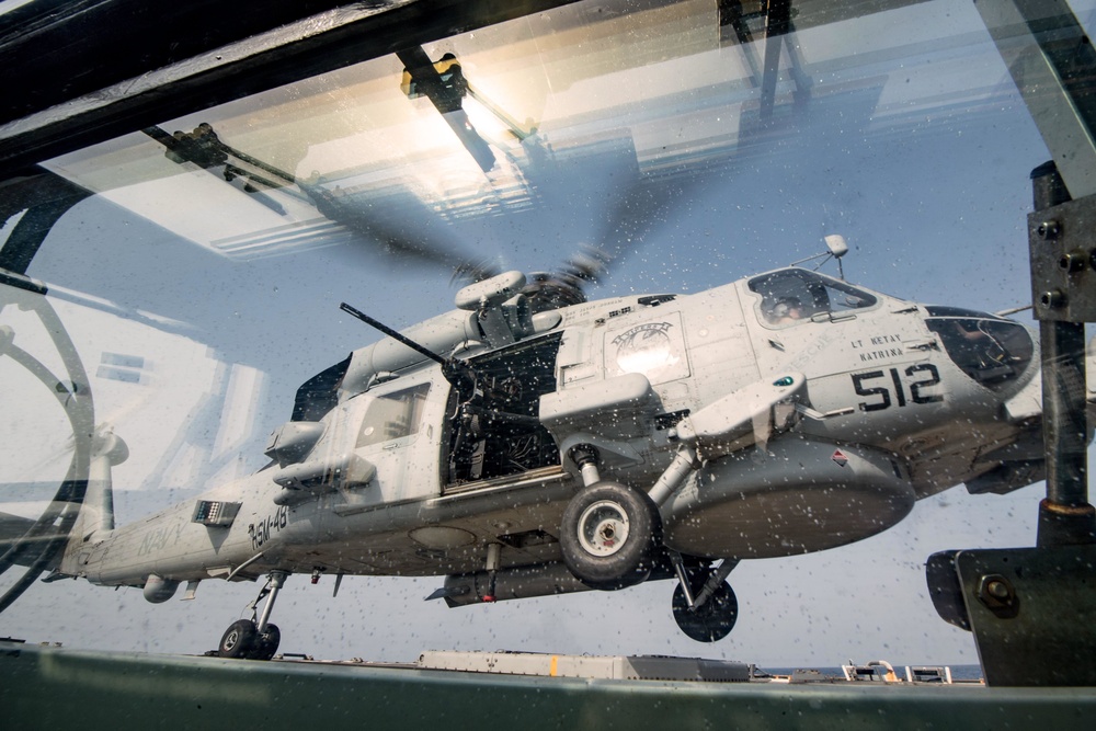Sailor performs machine gun maintenance on USS Jason Dunham (DDG 109)