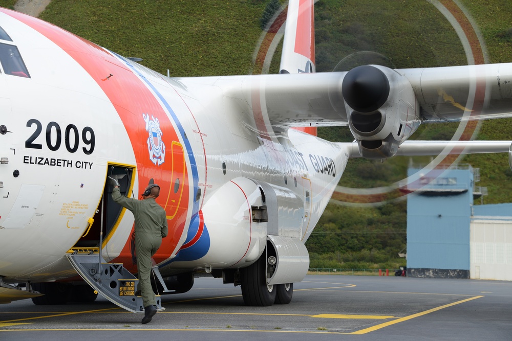 Petty Officer 1st Class William Dube boards a HC-130J Super Hercules in Kodiak, Alaska