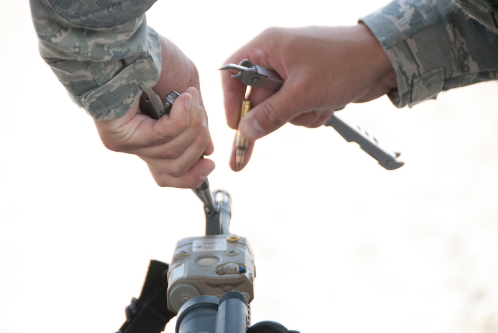 Air National Guardsman adjusts his site during weapons qualifications for deployment