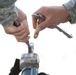 Air National Guardsman adjusts his site during weapons qualifications for deployment