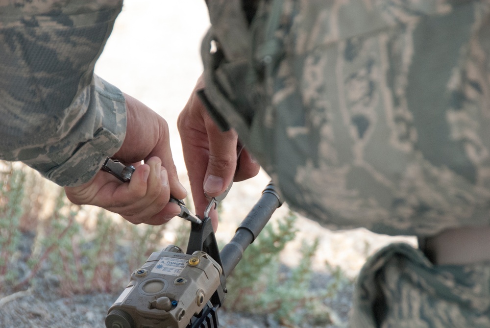 Air National Guardsman adjusts his site during weapons qualifications for deployment