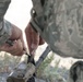 Air National Guardsman adjusts his site during weapons qualifications for deployment