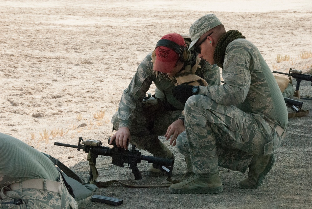 Air National Guardsman receives training on adjusting his weapon site during weapons qualifications for deployment