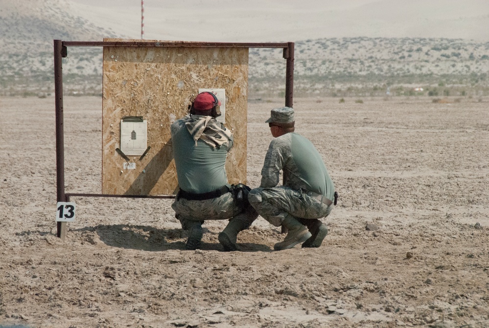 Air National Guardsman and his instructor check his target during weapons qualifications for deployment