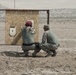 Air National Guardsman and his instructor check his target during weapons qualifications for deployment