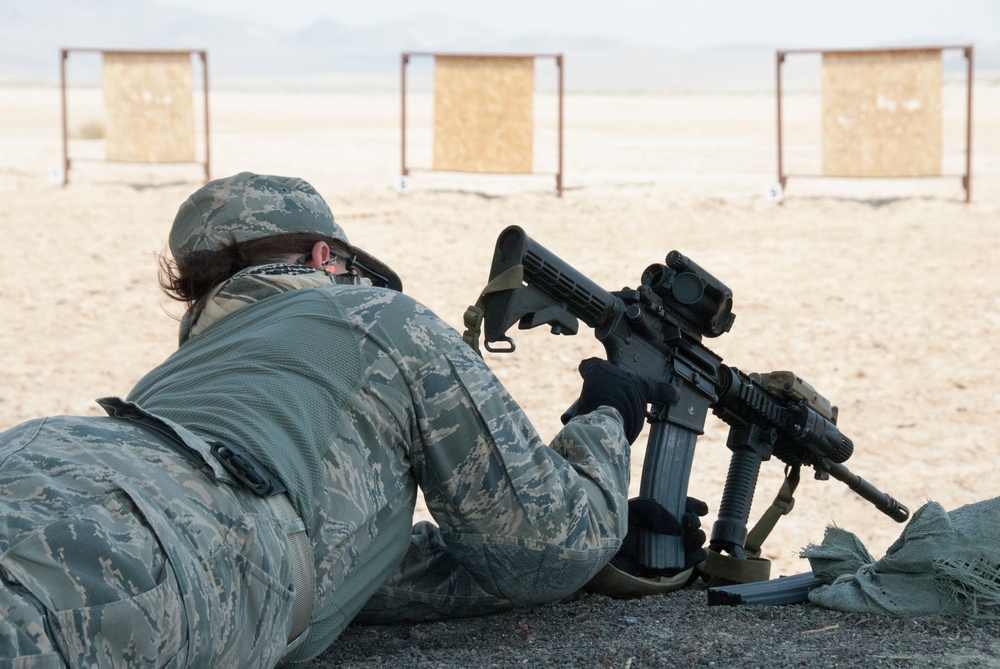 Air National Guardsman from Nevada inserts the magazine for her weapon during weapons qualifications training