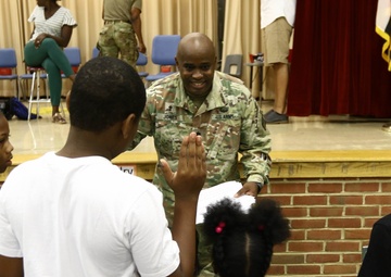 Haircuts and high fives: 20th CBRNE Soldiers welcome area elementary school students back to class
