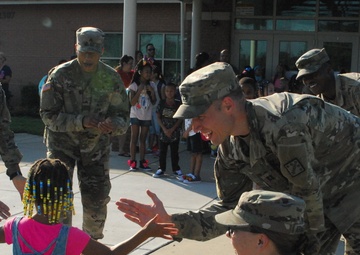 Haircuts and high fives: 20th CBRNE Soldiers welcome area elementary school students back to class