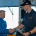 Fireman Kiel Knight, right, from Panama City, Florida, receives a Commanding Officer’s coin from Capt. Randy Peck, commanding officer of the Nimitz-class Aircraft Carrier USS John C. Stennis (CVN 74), as the Sailor of the Day.