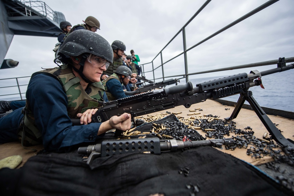 Master-at-Arms Seaman Jordan Steffen, from Chicago, racks an M240B machine gun during an M240B machine gun qualification exercise on the fantail aboard the Nimitz-class aircraft carrier USS John C. Stennis (CVN 74).