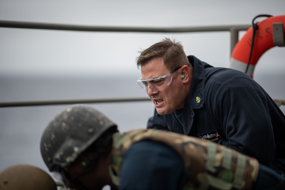 Chief Master-at-Arms Mark Durben, from Coshocton, Ohio, gives a Sailor instructions during an M240B machine gun qualification exercise on the fantail aboard the Nimitz-class aircraft carrier USS John C. Stennis (CVN 74).