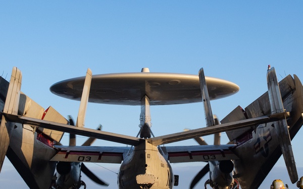Sailors guide an E-2C Hawkeye, with Carrier Airborne Early Warning Squadron (VAW) 117, into position on the flight deck prior to flight operations aboard the Nimitz-class aircraft carrier USS John C. Stennis (CVN 74).