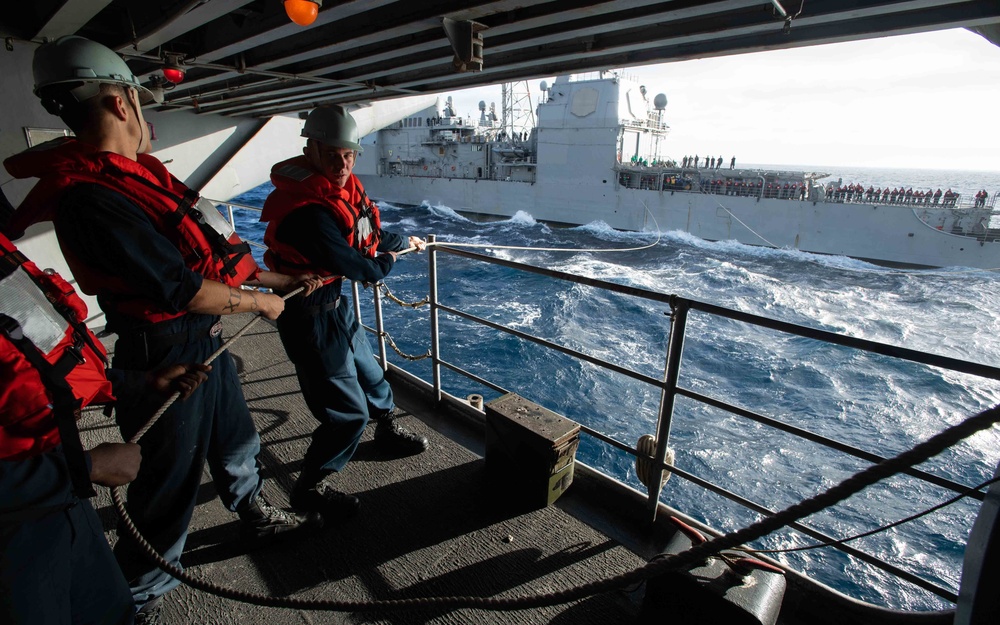 Seaman Cameron Skon, right, from St. Michael, Minnesota, and Boatswain’s Mate Seaman Apprentice Kyle Rooker, from Indianapolis, steady a communications line during a replenishment-at-sea