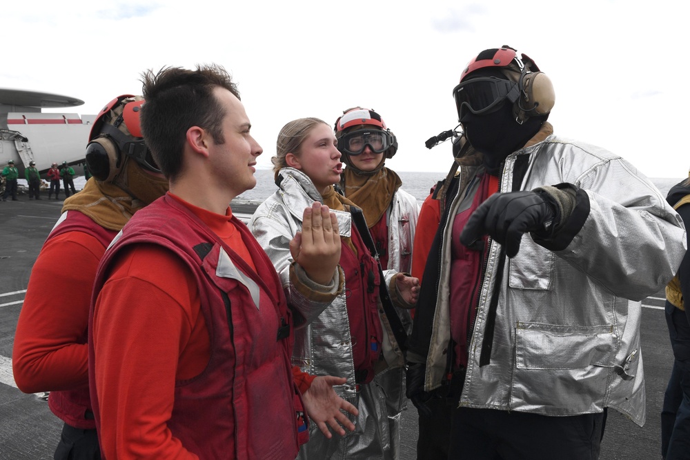 Sailors participate in a flight deck firefighting drill