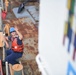 Seaman Joseph Griffin points to the Coast Guard Tahoma's bridge as the vessel sets sail for UNITAS 2018