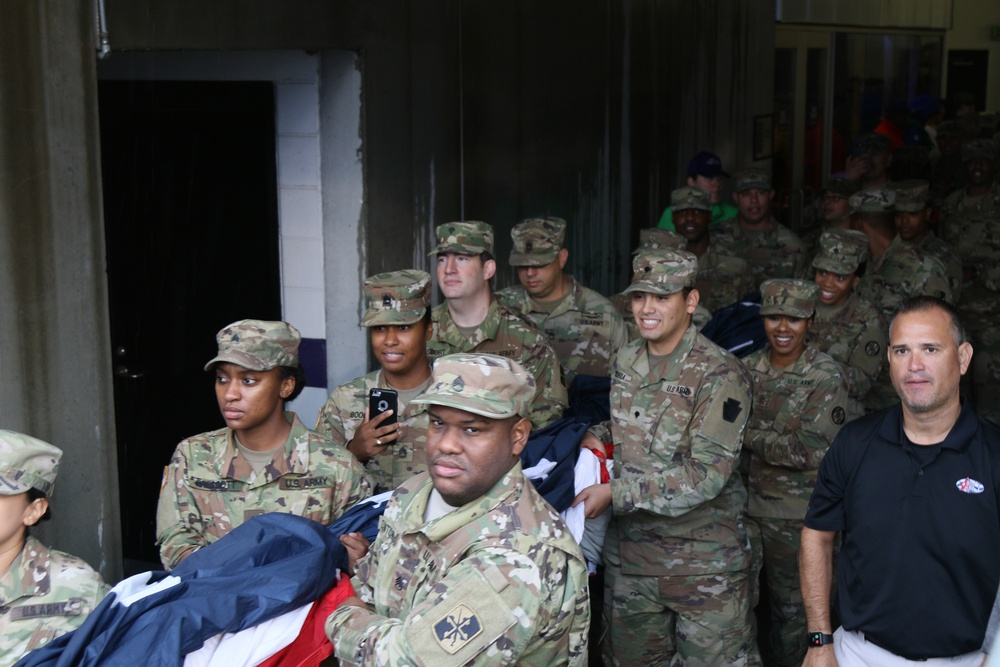 Maryland National Guard Soldiers and Airmen display flag at Baltimore Ravens Game