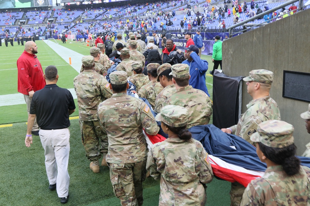 Maryland National Guard Soldiers and Airmen display flag at Baltimore Ravens Game