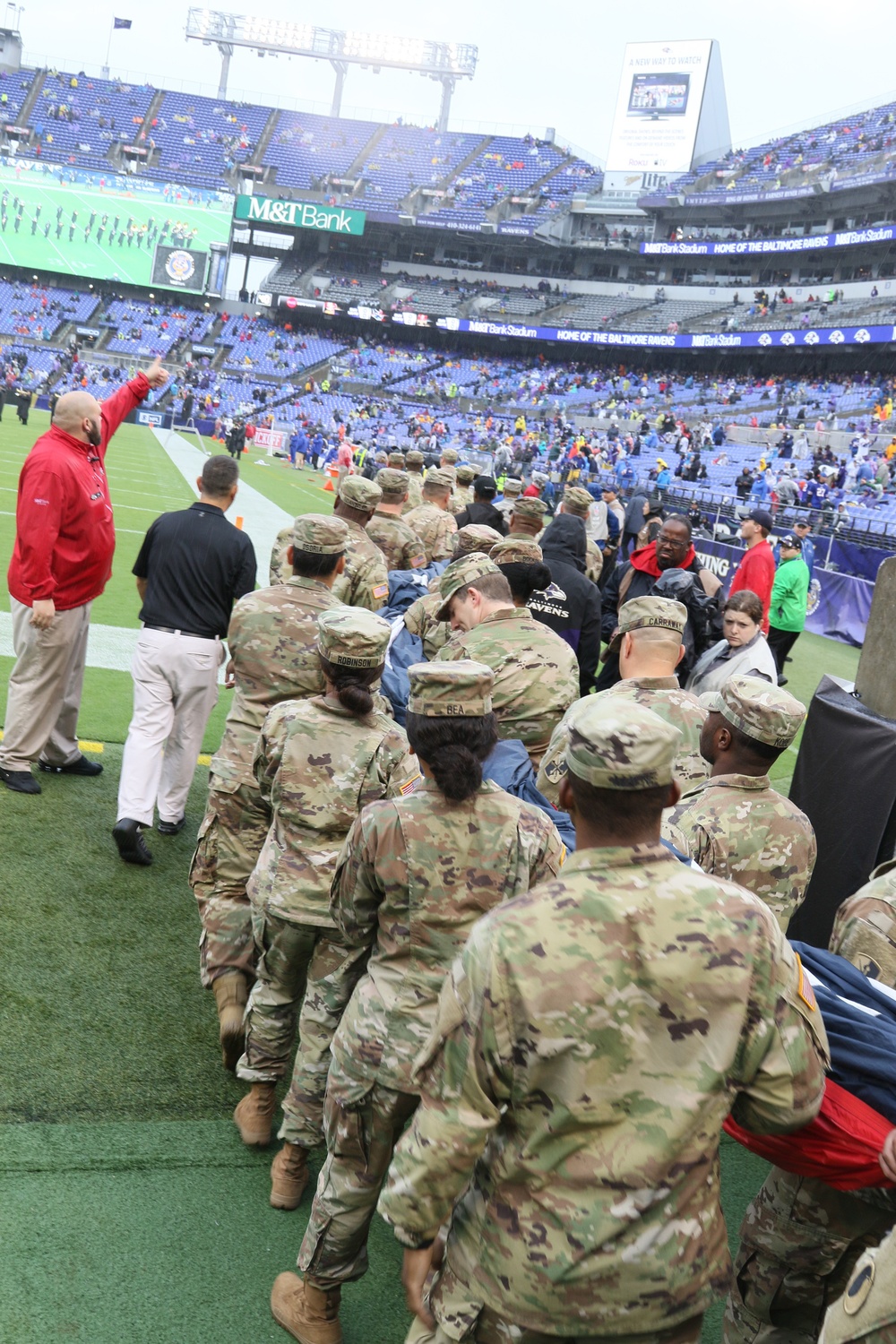 Maryland National Guard Soldiers and Airmen display flag at Baltimore Ravens Game