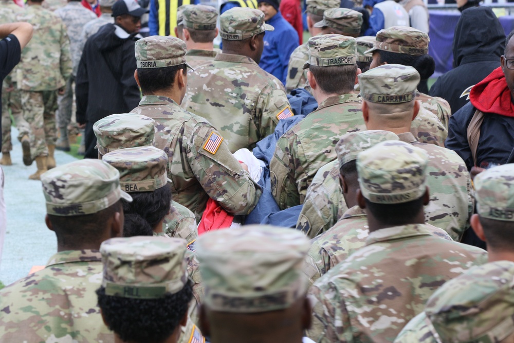 Maryland National Guard Soldiers and Airmen display flag at Baltimore Ravens Game