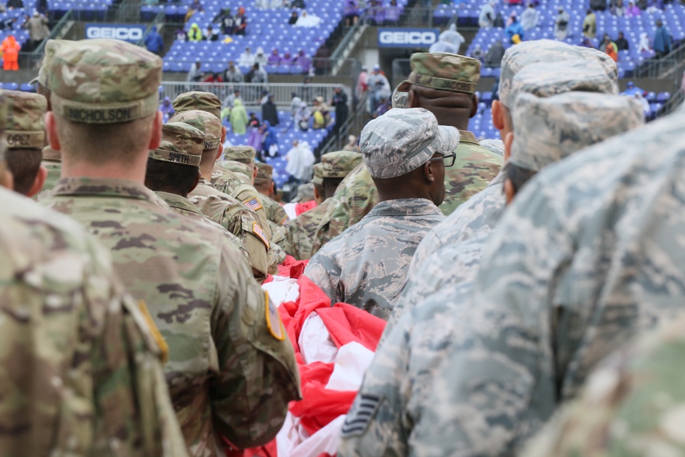 Maryland National Guard Soldiers and Airmen display flag at Baltimore Ravens Game