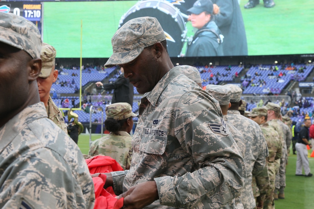 Maryland National Guard Soldiers and Airmen display flag at Baltimore Ravens Game